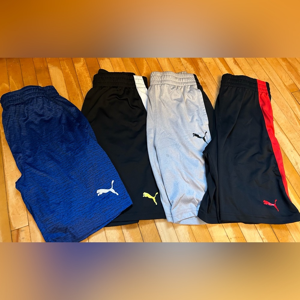 4 pair kids Puma shorts.  All size Medium besides blue pair is Small.